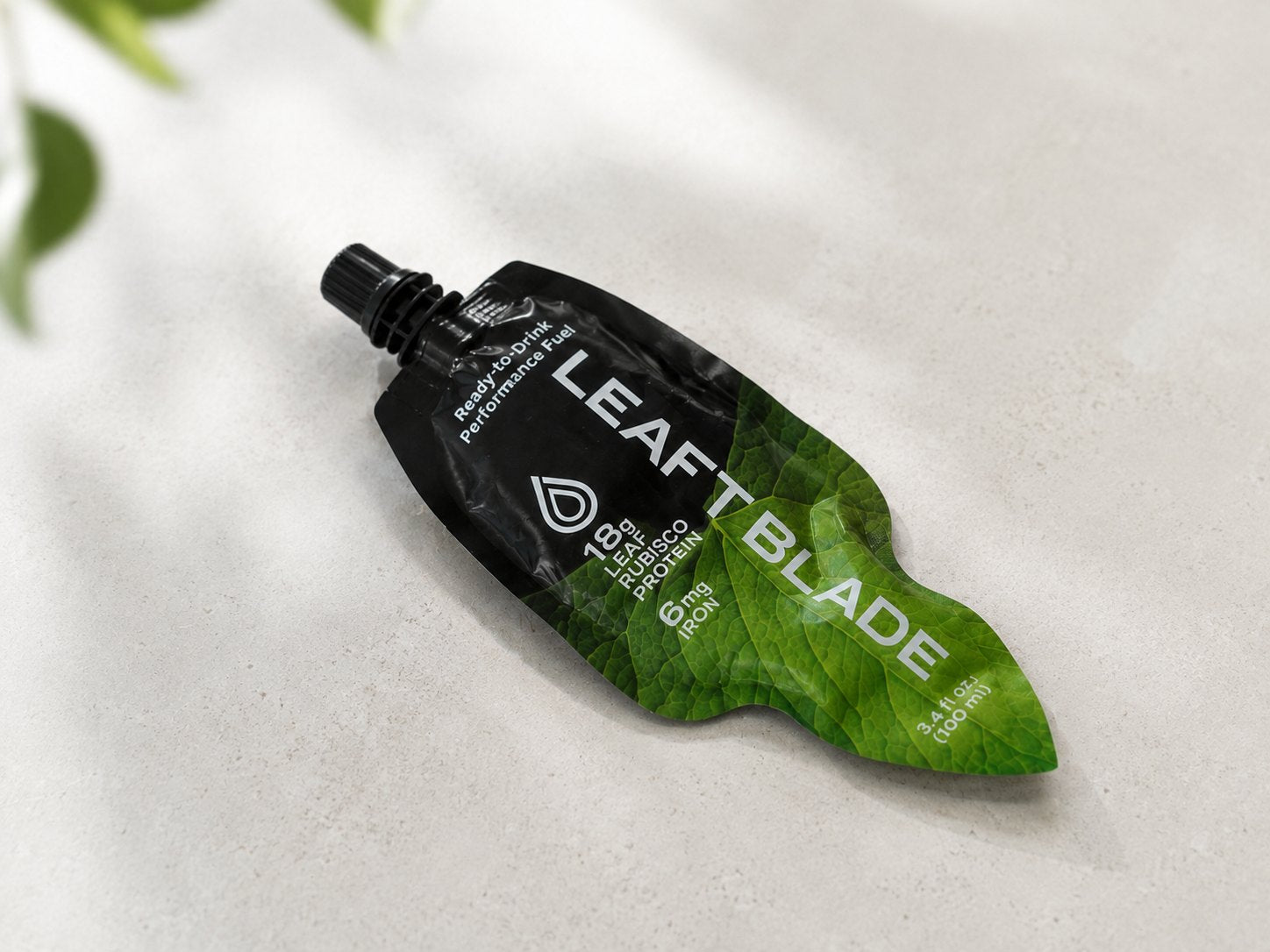 A Leaft Blade pouch lying on pale stone in soft daylight